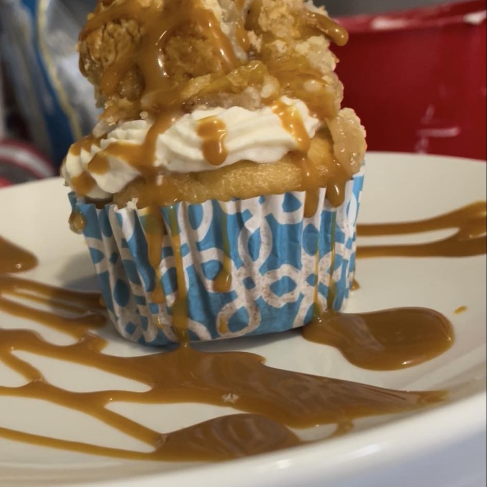 Caramel cupcake topped with whipped cream